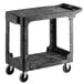 A black Rubbermaid plastic utility cart with wheels.