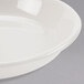 A close-up of a Homer Laughlin ivory coupe china soup bowl.