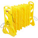 A yellow Rubbermaid portable safety barrier with a warning sign.