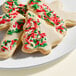 A close up of a plate of cookies decorated with Adourne Christmas Sprinkles.