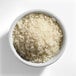 A white bowl filled with medium grain white sushi rice.
