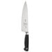 A Mercer Culinary Genesis chef knife with a black handle and silver blade.