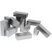 A stack of silver rectangular stainless steel block risers.