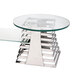 An Eastern Tabletop stainless steel riser with a cooking grate on a glass and metal coffee table.
