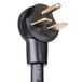 A close-up of the black power cord with gold electrical plug tips on a TurboChef Fire countertop pizza oven.