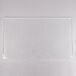 A clear rectangular acrylic buffet shelf on a white surface.