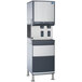 A large grey rectangular Follett ice and water dispenser with a large container on the bottom.
