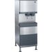 A stainless steel Follett 110 FB Series freestanding combination ice maker and water dispenser.