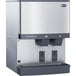 A silver and black Follett countertop ice and water dispenser with two water dispensers.