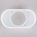 A white plastic circle with holes in it.