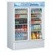 A Turbo Air white refrigerated merchandiser full of drinks with two glass doors.