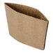 A natural Kraft brown corrugated cardboard coffee cup sleeve with a fold on it.