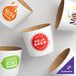 A white box of customizable white coffee cup sleeves with different designs.
