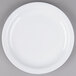 A Tuxton Colorado white plate with a narrow white rim on a gray surface.