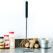 A Thunder Group potato masher with a soft grip handle being used to mash potatoes in a pot.