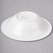 A Fiesta white china bowl on a gray surface.