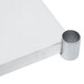 A white surface with a metal tube underneath it.