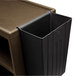 a black plastic bin with a brown surface