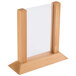 A close-up of a wooden frame with white paper inside.