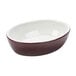 A Tuxton oval china baker bowl with a white rim.