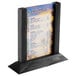 A Menu Solutions black wood table tent with a menu on a stand.