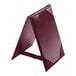 A Menu Solutions burgundy A-frame table tent with picture corners.