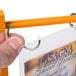 A hand flipping open a Menu Solutions Mandarin Wood table tent.