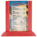 A Menu Solutions berry wood table tent holding a menu on a red table.