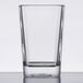 A clear square plastic shot glass.