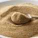 A spoon with brown celery salt in a bowl.