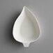 A white EcoChoice leaf shaped dish.