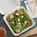 A salad in a white EcoChoice compostable take-out container.