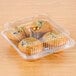 A Polar Pak plastic container with 4 muffins in it.