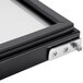 A close-up of a black and silver Avantco refrigeration door frame.