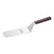 A Mercer Culinary Hell's Handle High Heat solid rounded edge turner with a brown handle.