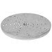 A circular stainless steel Vollrath shredding plate with holes in it.