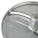 A close-up of a metal disc with a hole in it.