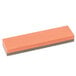 A rectangular orange and gray Victorinox sharpening stone with a black edge.