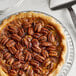 A pecan pie with Regal Jr. Mammoth raw pecan halves on top.