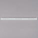 A white plastic strip with holes on it.