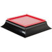 A red and black square plastic top for a Paragon popcorn machine.