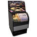 A black Structural Concepts Oasis dual service merchandiser display case on a bakery counter with food inside.