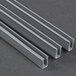 A close-up of three grey metal profiles for a Paragon TP-16 popcorn popper.
