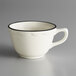 A CAC ivory china mug with a black scalloped edge.