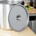 A large silver stainless steel pot cover.