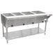 An Advance Tabco stainless steel electric steam table with an undershelf holding large stainless steel containers of food.