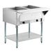 A stainless steel two-pan natural gas powered hot food table with an open well and lower shelf.