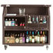 A dark brown Cambro portable bar cart with bottles of alcohol.