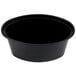 A black oval plastic souffle container with a lid. 