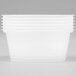 A stack of clear oval plastic Newspring portion cups with lids.